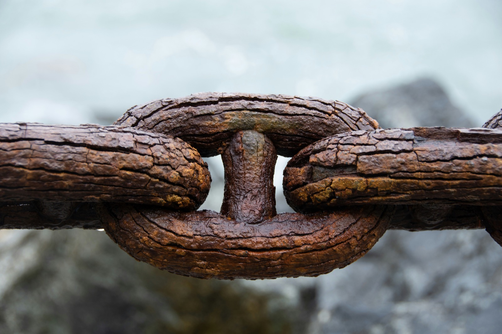 Weathered chain links representing the missing connection between advisors and the philanthropy conversation