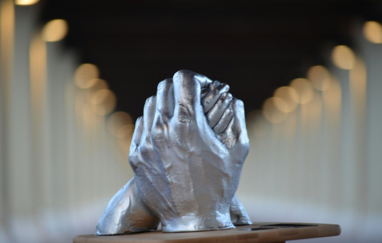 Clasped hands representing trust and partnership in philanthropy
